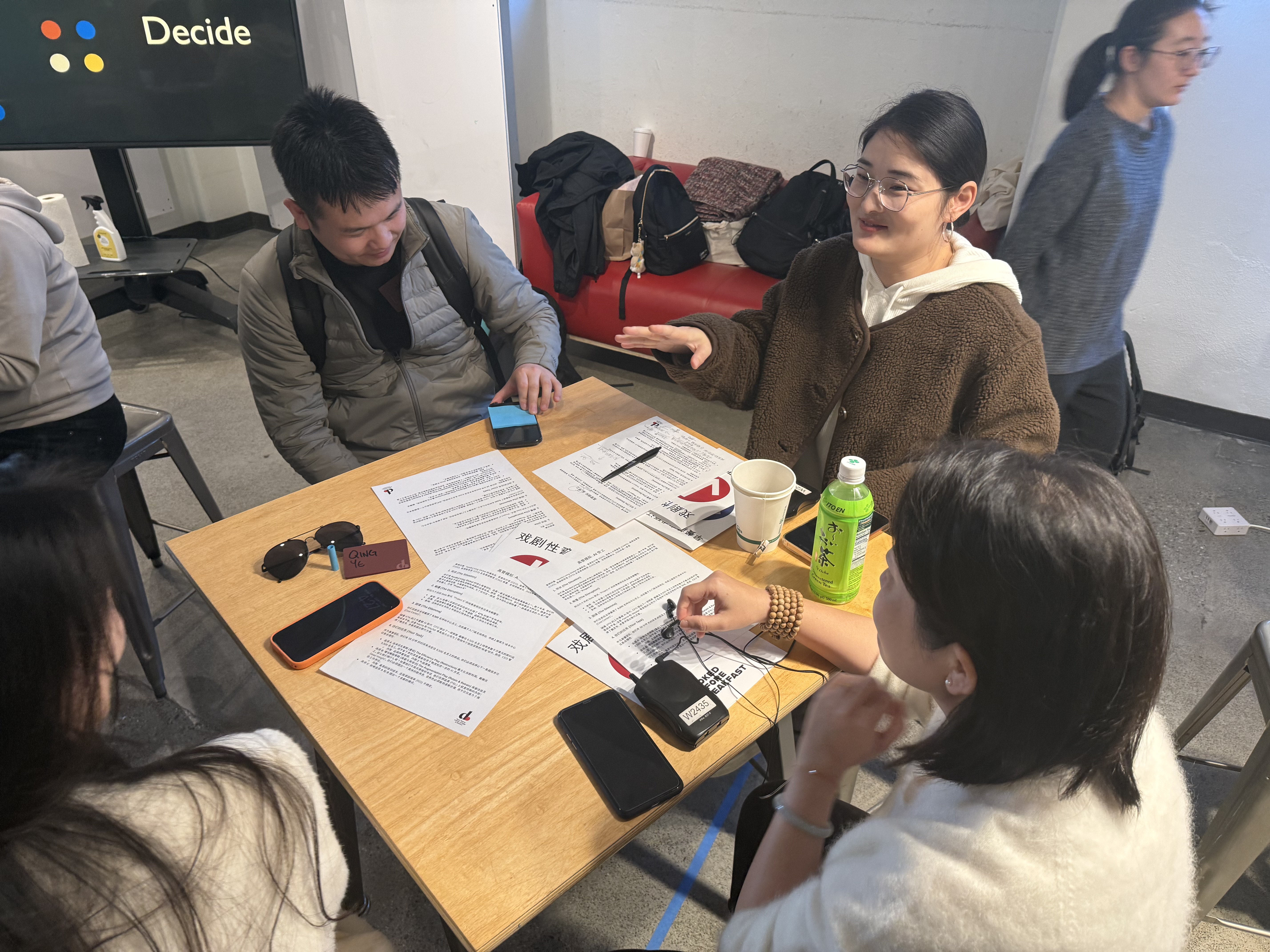 Participants reviewing printed case study materials and deliberating on their recommendation